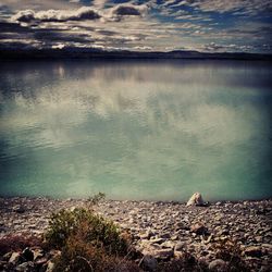 Scenic view of sea against cloudy sky