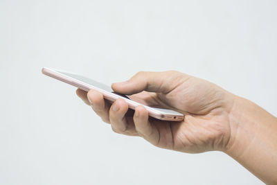 Close-up of man using mobile phone against white background