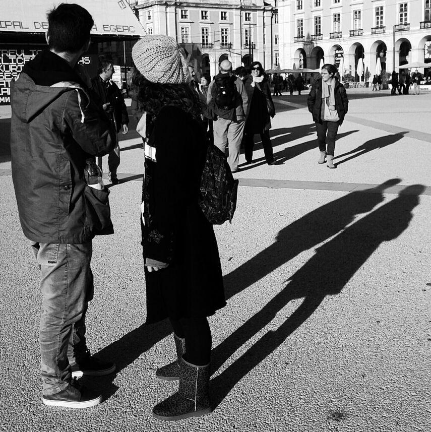 street, walking, city, men, city life, lifestyles, full length, building exterior, person, architecture, built structure, casual clothing, rear view, leisure activity, large group of people, city street, togetherness, road, day