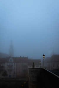 Buildings in city against sky at dusk