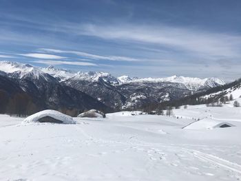 Snow covered landscape against sky