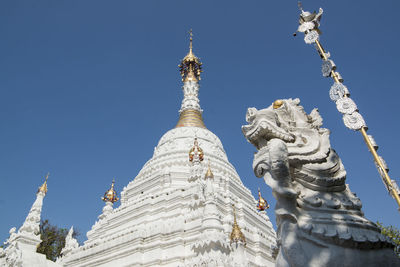 Low angle view of statue against clear blue sky