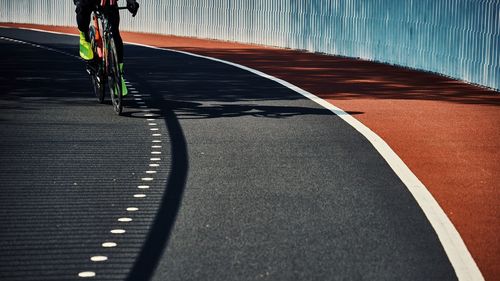 Rear view of man walking on road