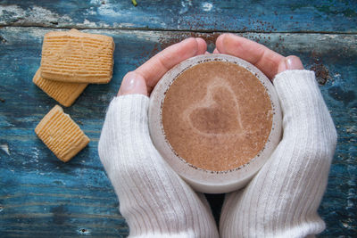 Woman holding coffee cup