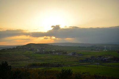 Scenic view of field against sky during sunset