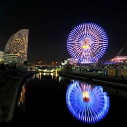 Illuminated ferris wheel at night