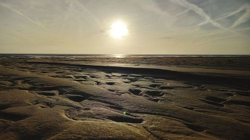 Scenic view of beach against sky during sunset