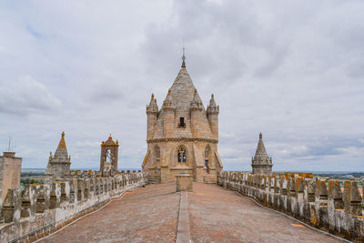 Old church in city against cloudy sky