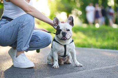 Low section of woman with dog