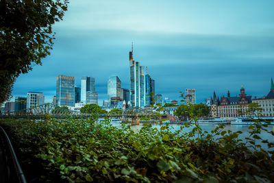 View of modern buildings against cloudy sky