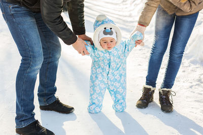 Full length of father and son in snow