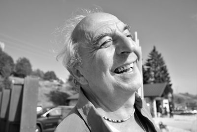 Close-up of happy man against sky