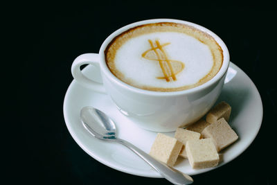 Cup of coffee on black background