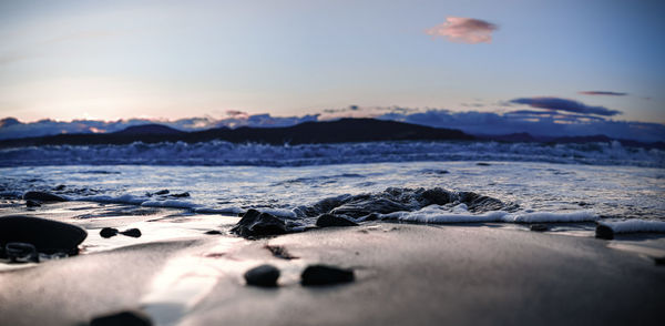Scenic view of beach against sky during sunset
