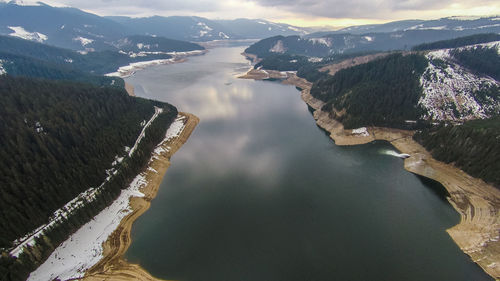 High angle view of river amidst mountains against sky