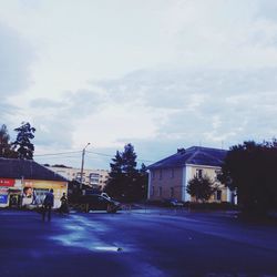 Empty road with buildings in background