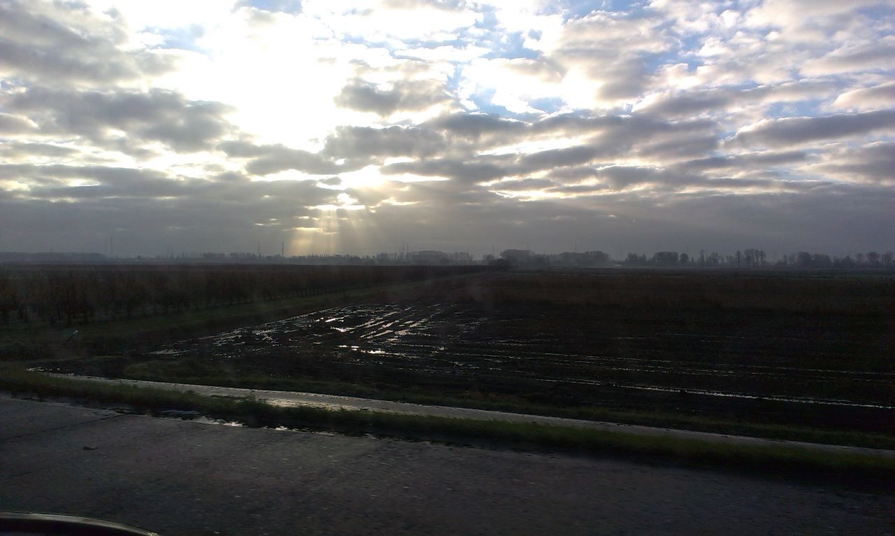 sky, cloud - sky, sun, sunset, landscape, sunbeam, tranquil scene, field, tranquility, scenics, cloudy, beauty in nature, nature, sunlight, cloud, lens flare, rural scene, road, weather, idyllic