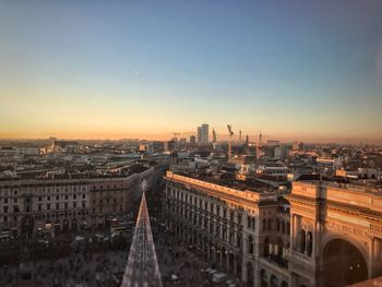 High angle view of city buildings against sky during sunset