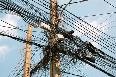 Low angle view of electricity pylon against sky