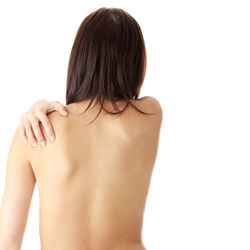 Rear view of a serious young woman over white background