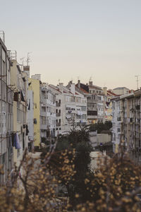 Buildings in city against clear sky