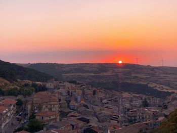 High angle view of buildings against sky during sunset