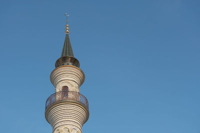 Low angle view of bell tower against blue sky