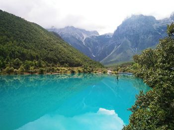 Scenic view of lake and mountains against sky