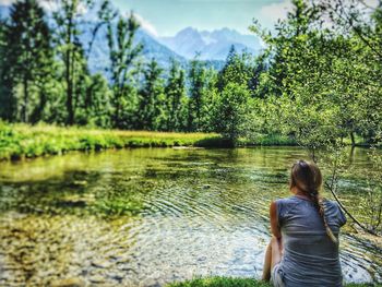 Scenic view of river with mountains in background