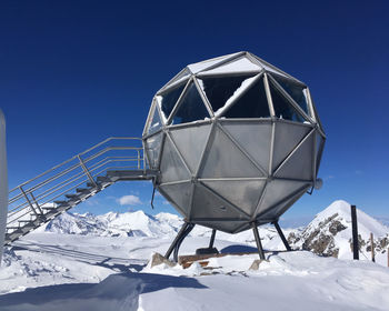 Low angle view of snowcapped mountain against sky