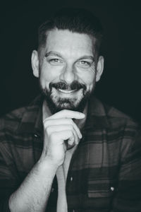 Portrait of mature man against black background