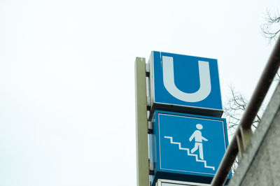 Low angle view of road sign against clear sky