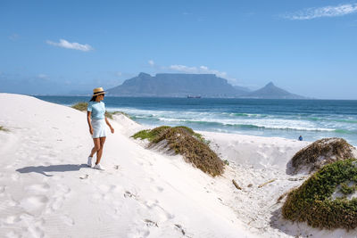 Full length of woman standing on beach