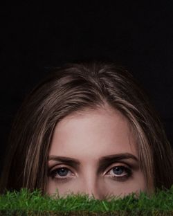 Portrait of beautiful woman against black background