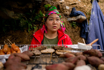 Portrait of smiling man preparing food at market