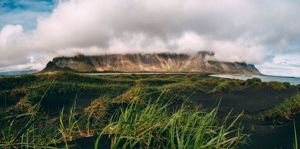 Scenic view of landscape against cloudy sky