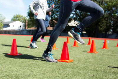 Low section of people running on grassland