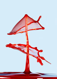 Close-up of red umbrella against sky