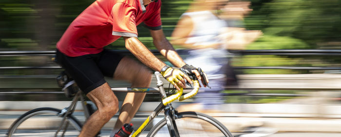 Blurred motion of man riding bicycle