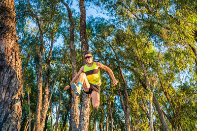 Low angle portrait of young woman in forest