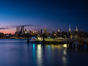 Sunset over east river midtown manhattan skyline and north 5th street pier at brooklyn