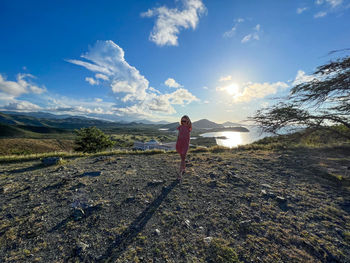 Rear view of woman walking on mountain against sky on the margarita island in venezuela 