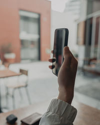 Midsection of man using smart phone