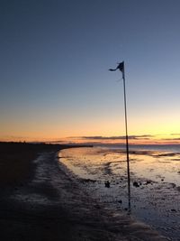 Scenic view of sea against clear sky during sunset