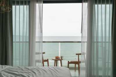 Table and chairs on the balcony with sea view. summer concept.