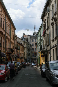 Vehicles on road amidst buildings in city