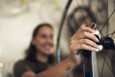 Close-up of woman hand repairing bicycle