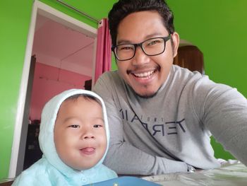 Portrait of smiling boy with baby