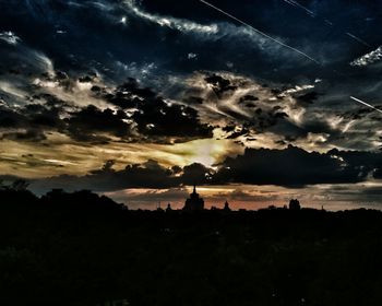 Silhouette landscape against scenic sky