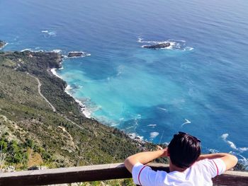 High angle view of woman looking at swimming pool